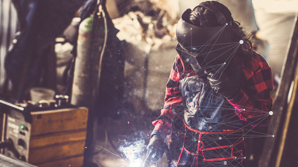 person welding in a shop